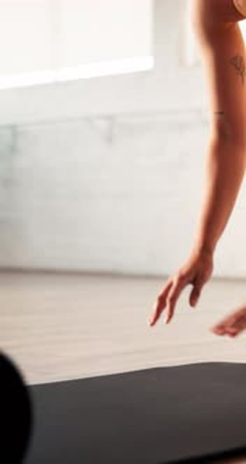 Feet, hands and rolling mat with woman in yoga studio for start of holistic or wellness routine