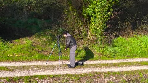 Man Sets Up Camera to Film on Trail