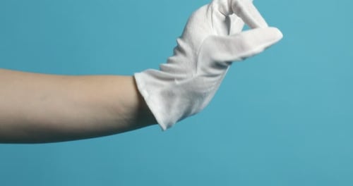 Hand in White Glove Pointing on Blue Background