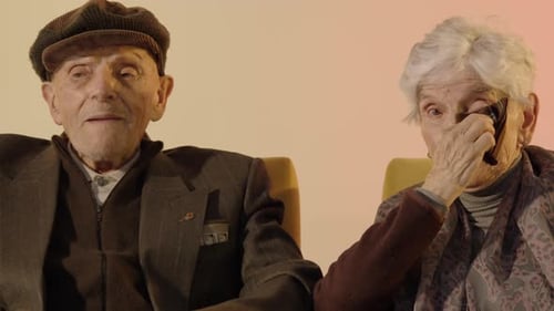 Elder couple talking to camera