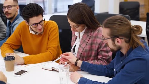 Office Employees Sit and Discuss on Startup Project in Conference Room with Charts Team of Business