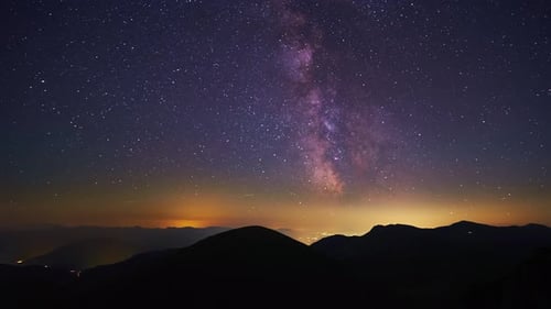 The Stars of the Milky Way Galaxy Move Above the Mountain Hills