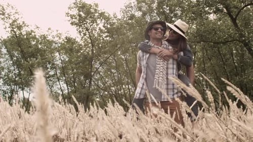 Piggyback. Casually Dressed Heterosexual In-Love Couple Having Fun Together In Field. Steadicam S...
