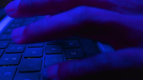 Hacker informático escribiendo código Virus PC en el teclado trabajando tarde por la noche