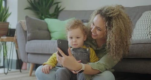 Mother and Child Looking at Phone Together