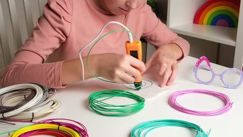 Child Creating Art with 3D Pen and Filaments