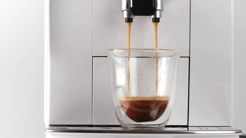 Coffee Pouring Into Glass From White Machine