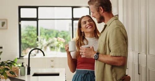 Affectionate Couple Drinking Coffee Together in Modern Kitchen