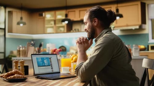 Adult Male Browsing a Videosharing Website Using Laptop