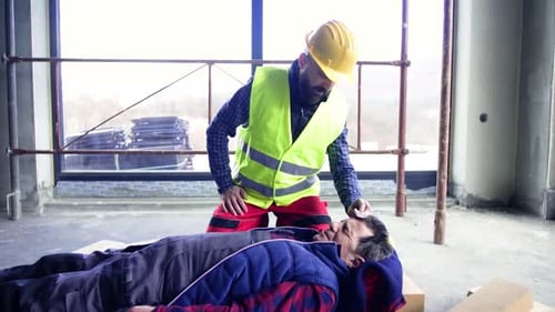 Construction Worker Helps Injured Colleague at Construction Site