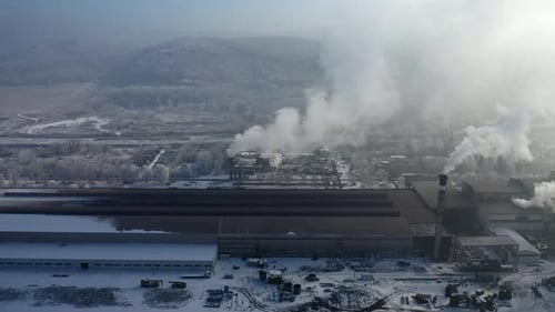 Aerial view of steelworks in industrial zone. Factory chimneys smoking. Heavy industry from above.