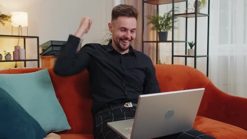 Overjoyed Young Guy Working on Laptop Celebrate Success Win Money in Lottery Get Online Good News