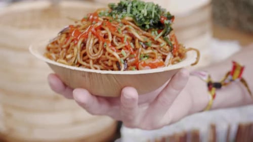 Chef Cooking Fried Chinese Japanese Noodles with Vegetables and Shrimps for Takeaway Box Food