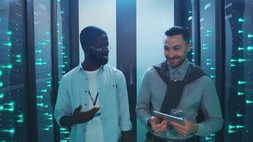 Two Men Analyze Data in a Hightech Server Room Showcasing Teamwork