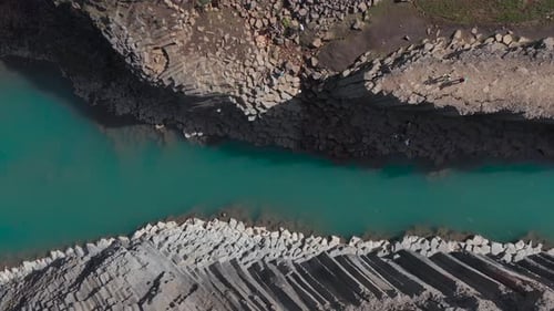 Volcanic basalt column formation canyon in Iceland with blue water, Stuðlagil, top down