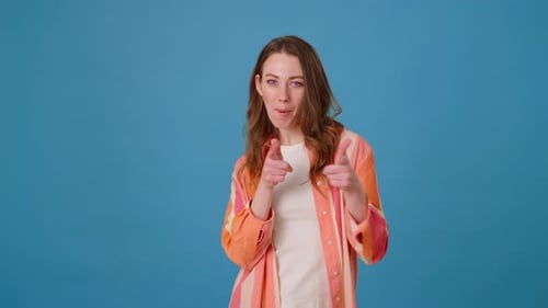Enthusiastic Woman Gesturing Positively on Blue Background