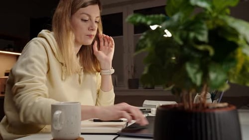 Woman Working at Desk with Laptop at Home