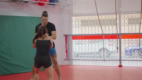 Woman Boxing With Personal Trainer