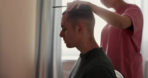 Woman Cuts Man's Hair at Home