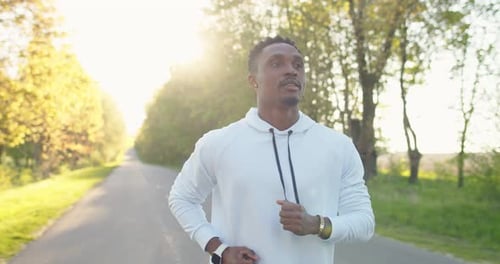 Close Up of Young Handsome Afro Male Athlete Jogging Outdoors Alone on Street African American Young