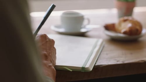 Woman hands writing notebook in cafe for creative ideas, schedule notes and planning paper schedule