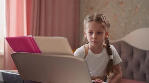 Diligent Girl Plays Electronic Keyboard at Home