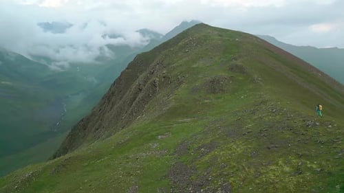 Woman Solo Hiker Going Uphill To The Top (Panning View)