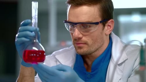 Chemist in Lab. Close Up of Chemist Doing Chemical Research at Chemical