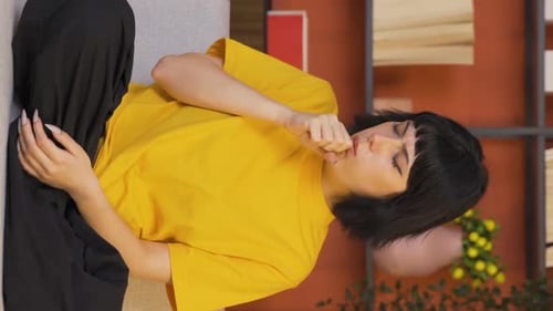 Young Woman Coughing While Lying on Couch