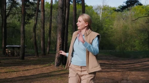 Woman Dancing Expressively in Sunny Forest