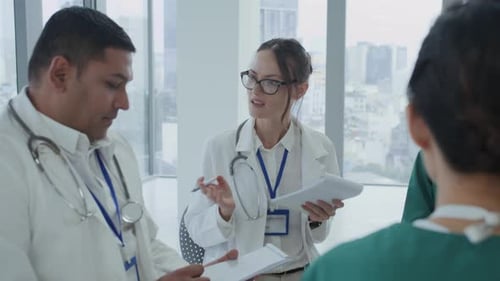 Diverse Doctors Talking about Working Plan during Meeting in Clinic