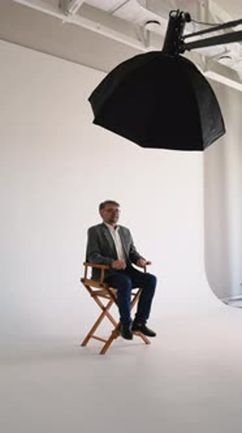 Professional Businessman Sitting in a Director's Chair