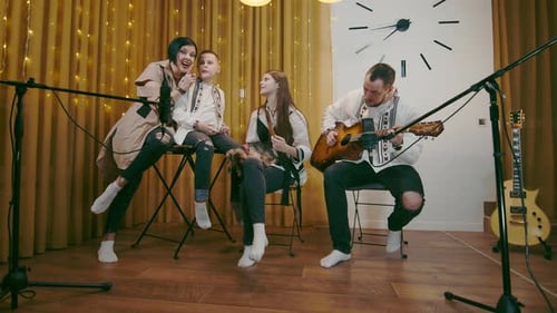 Family Performs Music Together in Cozy Home Setting