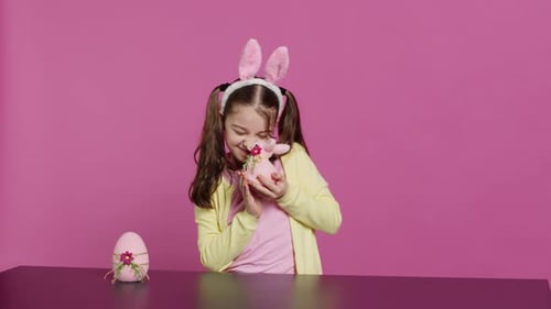 Girl with Rabbit Ears Holding Easter Toy