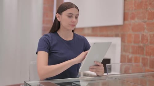 Woman Using Tablet Device in Bright Indoor Setting