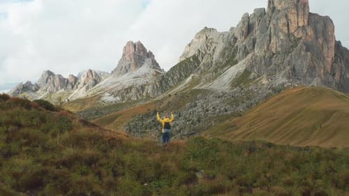 Tourist Raises Hands and Enjoys Exploring High Mountain Pass