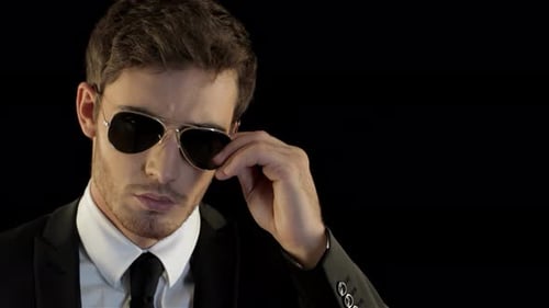 Young Adult Man Removes Sunglasses