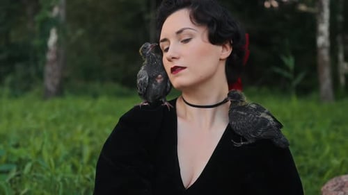 An Elegant Woman Surrounded By a Diverse Range of Birds in a Lush and Vibrant Green Landscape