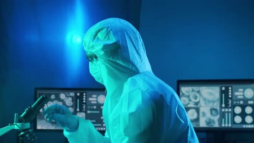 Scientist with Microscope in Blue Laboratory Setting