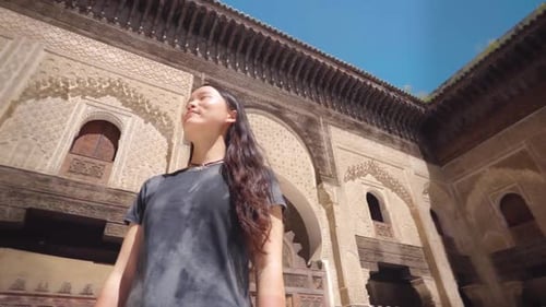Young Woman Explores Intricate Historic Building Courtyard