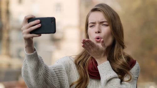 Woman Taking Expressive Selfies in Urban Setting