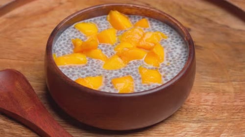 Chia Seed Pudding with Mango in Wooden Bowl