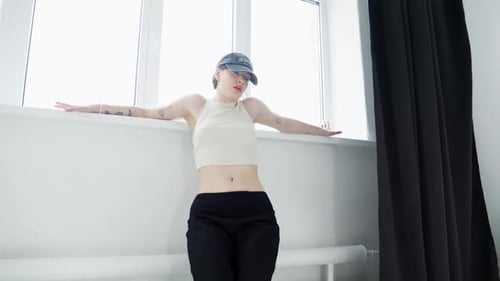 Stylish Woman Dancing in Bright Studio Apartment