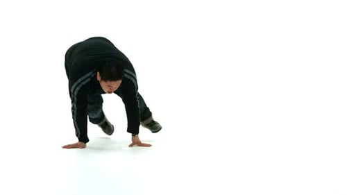 Young male hip hop dancer performing modern moves in slow motion studio shot