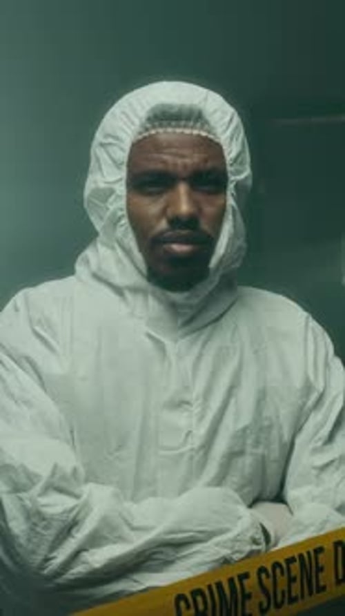 Adult in Protective Suit in a Crime Scene