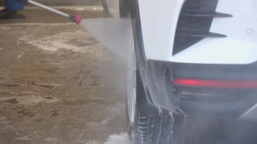 Closeup of a Woman Washing a Car at a Selfservice Car Wash
