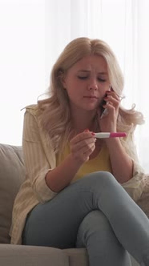 Worried Woman on Phone Holding Medical Test Device