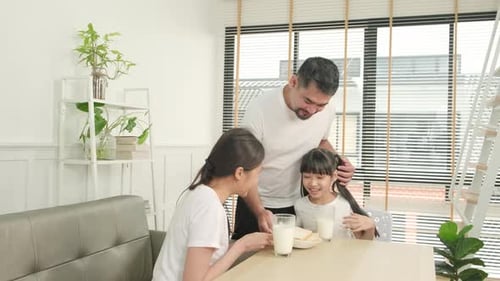Family having breakfast in bright, modern kitchen