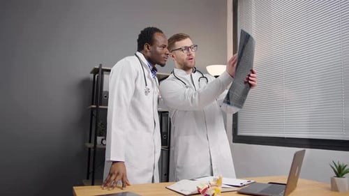 Doctors Reviewing X-Ray Scan in Office