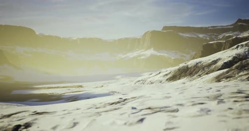 Captivating Snowy Landscape with Mountain Range Under Golden Light